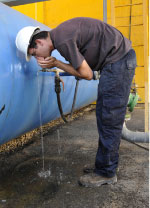 عامل إسرائيلي يشرب مياهاً مكرّرة جنوبي تل أبيب (أ ف ب)