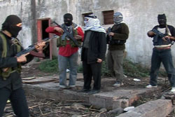 العبسي مع مسلحين من “فتح الإسلام” في نهر البارد (أرشيف)