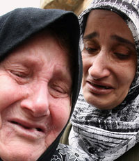 امرأتان فلسطينيتان تنتحبان عقب اجلائهما من مخيم نهر البارد امس (رمزي حيدر - أ ف ب)