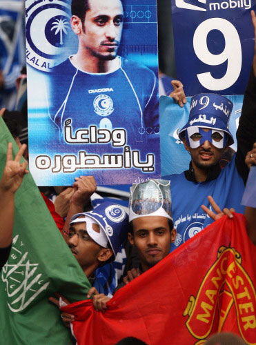 جمهور سعودي يرفع علمي مانشستر والهلال وصورة للجابر (حسن عمار ــ أ ف ب)