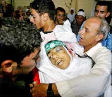 فلسطينيون يحملون جثمان شهيد قتله الاحتلال الاسرائيلي في خان يونس في غزة أمس (رويترز)