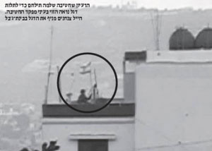 جندي  إسرائيلي يرفع علماً فوق منزل في بنت جبيل