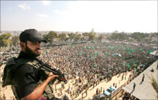 عنصر من القوة التنفيذية يشرف على المتظاهرين في غزة أمس (رويترز)