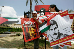 لبنانيّون يحضّرون اللافتات لاستقبال القنطار في صيدا أمس (علي حشيشو ـــ رويترز)