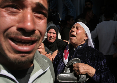 فلسطينيّون ينتحبون خلال تشييع جثمان الشهيد رامز الزعانين في بيت حانون في قطاع غزّة أمس (حاتم موسى - أ ب)
