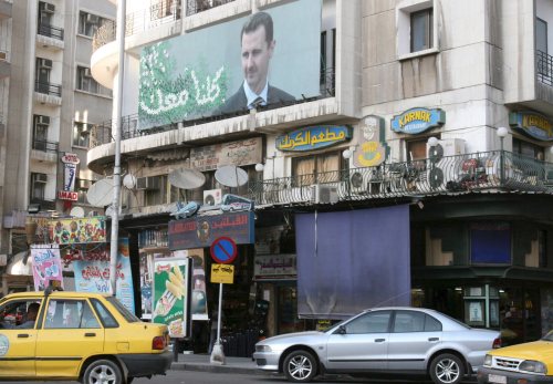 صورة للأسد في أحد شوارع دمشق أول من أمس (يوسف بدوي - إي بي أي)