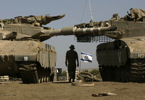 جندي يتوسط دبابتين إسرائيليتين في مرتفعات الجولان الأسبوع الماضي (أرشيف - أ ب)