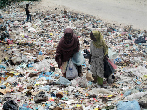 صوماليّون يبحثون عن الطعام بين أكوام القمامة في مقديشو أول من أمس (فرح عبدي وارسامه - أ ب)