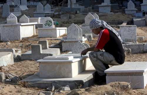 فلسطيني يزور قبر شقيقه الشهيد في غزّة أول من أمس (محمد صابر ـ إي بي إي)