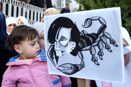 طفلة مرعوبة من صورة لرايس خلال تظاهرة ضدّ «أنابوليس» في عمّان أمس (جمال نصر الله ـ إي بي أي)
