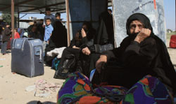 مصريّات ينتظرن تصريحاً للعودة إلى الأراضي المصريّة عند معبر رفح (إياد بابا ـــ أ ب)
