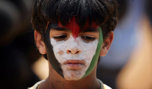 طفل يرسم علم فلسطين على وجهه في إحياء ذكرى النكبة في رام الله (دايفيد فورست ـــ أ ف ب)
