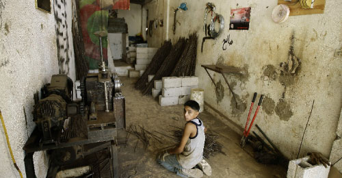 فتى فلسطيني داخل محل حدادة في مخيّم البداوي شمال لبنان (جوزف عيد ــ أ ف ب)