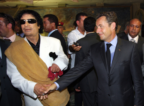 القذافي يستقبل ساركوزي في طرابلس أمس (باتريك كوفاريك - أ ف ب)