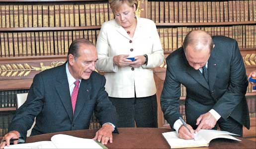 بوتين وميركل وشيراك يوقعون «السجل الذهبي» في قصر كونبين اول من امس (أ ف ب)