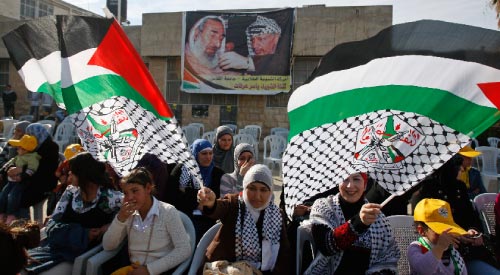 صورة لعرفات وأحمد ياسين في مسيرة في ذكرى تأسيسي «فتح» في الضفة الغربية (محمد تركمان ــ رويترز)