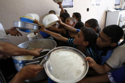 أطفال فلسطينيون يتهافتون للحصول على الطعام في الضفة الغربية الأسبوع الماضي (صائف دحلح ــ أ ف ب)