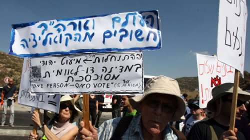 إسرائيليون معارضون للإستيطان يتظاهرون في الضفة الغربية أمس (عباس موماني - أ ف ب)