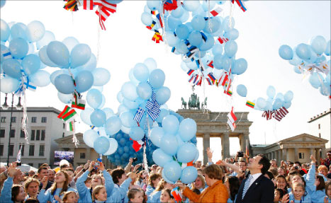 باروسّو وميركل يحتفلان مع 27 طفلاً عند «بوّابة براندنبرغ» في برلين أمس (أ ب)