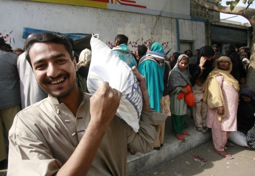 باكستانيّون يتزاحمون على شراء المواد الغذائيّة في كراتشي أمس (عطّار حسين - رويترز)