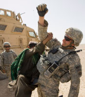 جندي أميركي يلهو مع طفل أفغاني في قندهار الجمعة الماضي (شاميل زوماتوف - رويترز)