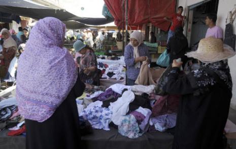 يتسوقن في أحد الأسواق الشعبية بعد عودة الهدوء في تونس (فتحي بليد ــ ا ف ب)  