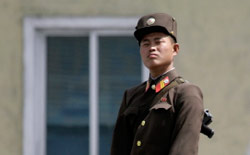 جندي في الجيش الكوري الشمالي يقف على ضفاف نهر يالو أول من أمس (جايسون ليي - رويترز)