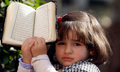 طفلة مصريّة تحمل القرآن وهي تتظاهر تضامناً مع غزة في القاهرة (عمرو دلش ـــ رويترز)