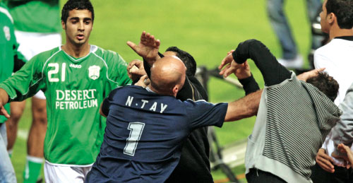 حارس الصفاء نزيه طي في مواجهة اثنين من جمهور الأنصار تحت أنظار اللاعب محمد حمود (محمد علي)