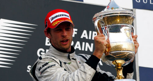 سائق «براون جي بي» البريطاني جنسون باتون حاملاً كأس المركز الأول في جائزة البحرين الكبرى (ستيف كريسب ـ رويترز)